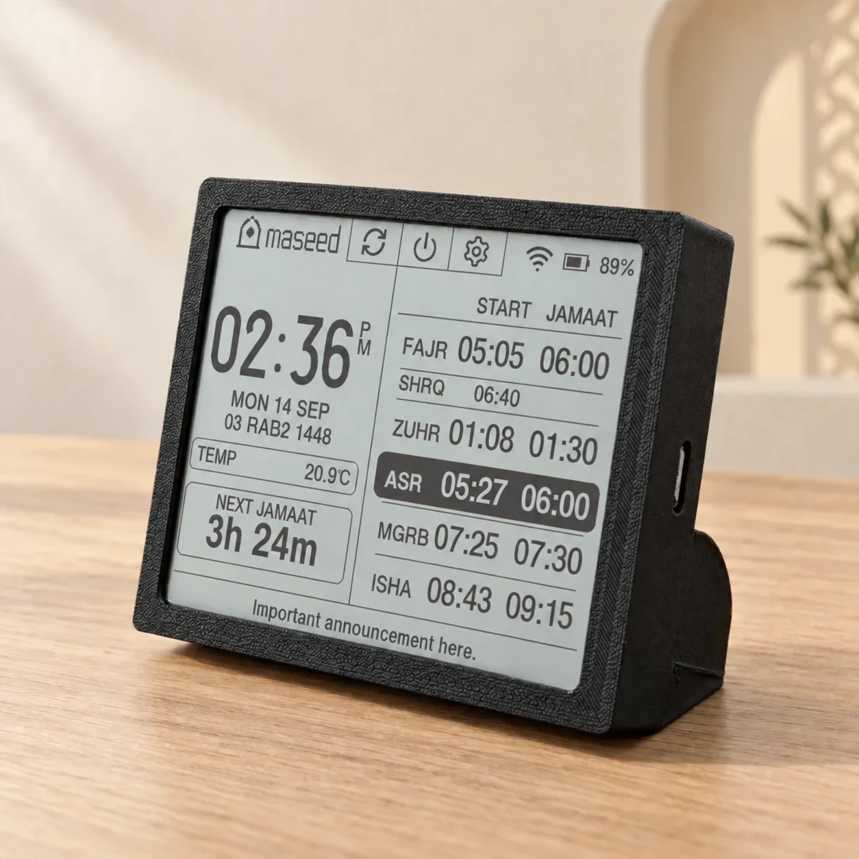 Black S100 Home Companion with a reflective LCD mosque timetable and desk stand